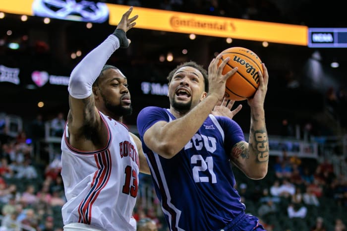 Mar 14, 2024; Kansas City, MO, USA; TCU Horned Frogs forward JaKobe Coles (21) drives to the basket around Houston Cougars forward J'Wan Roberts (13) during the second half at T-Mobile Center.